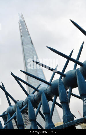 An unusual or different view of the shard office building in London Bridge with some spiky railings in the foreground. Alternative view of iconic site Stock Photo
