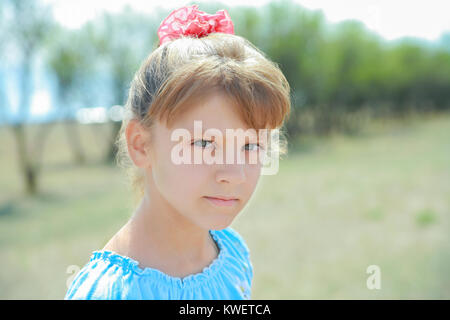 Little girl outdoors looking at the camera, close Stock Photo