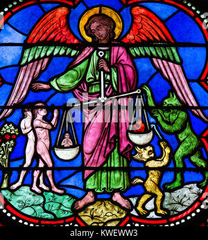 Stained glass window depicting Saint Michael the Archangel at the Final Judgement, in Bayeux, Calvados, France. Stock Photo