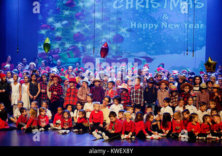 All the children of their school onstage singing at their christmas concert Stock Photo
