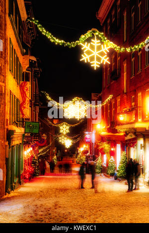 Christmas decorations and fresh snow in Quebec City's Petit Champlain area at night in Rue Petit Champlain Stock Photo