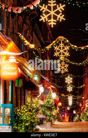 Christmas decorations and fresh snow in Quebec City's Petit Champlain area at night - in Rue Petit Champlain Stock Photo