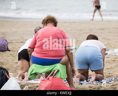 A group of elderly local women at their daily exercise class on Las Canteras beach in Las Palmas, Gran Canaria, Canary Islands, Spain. Stock Photo
