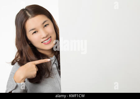 Beautiful Asian woman displaying a bit of attitude while holding a blank card isolated on a white background Stock Photo