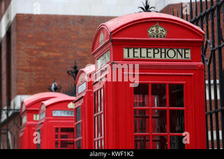 Classic old red telephone boxes pictured on a street in London, UK. Stock Photo
