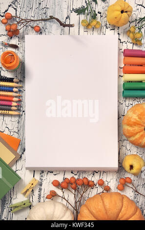 Creative artist workspace, top view. Mockup for your painting or drawing. Art stationery, Autumn decorations, pencils, paper tags, paints and brushes, Stock Photo