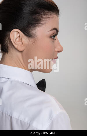 Pensive mood. Appealing kind brunette woman posing on the isolated background  while deciding what to do next Stock Photo