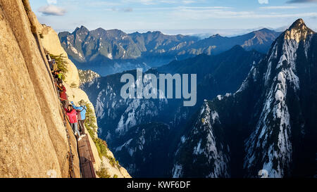 Mount Hua, Shaanxi Province, China - October 6, 2017: Tourists on the Plank Walk in the Sky, worlds most dangerous trail. Stock Photo