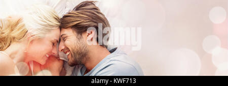 Cute couple relaxing on bed smiling at each other Stock Photo