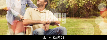 Smiling man in wheelchair talking with partner Stock Photo