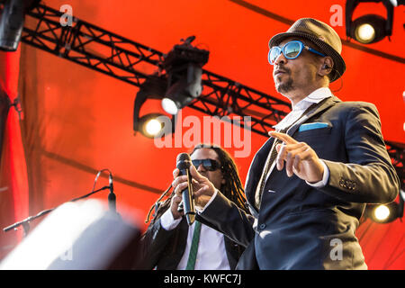 The German reggae and dancehall band Seeed performs a live concert at the Orange Stage at Roskilde Festival 2014. Here singer Boundzound is seen live on stage with Dallé in the bagground. Denmark, 04/07 2014. Stock Photo