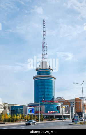 Blue modern architecture circular building with shops and communications transmitter mast in Nur-Sultan (Astana), capital city of Kazakhstan Stock Photo