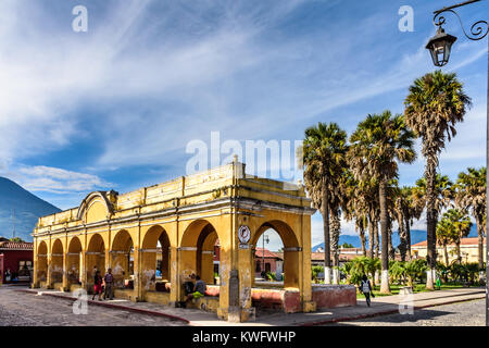 Antigua, Guatemala - October 22, 2017: Tanque de la Union public laundry tank in UNESCO World Heritage Site with Agua volcano behind Stock Photo