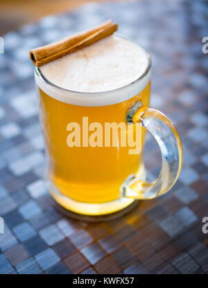 A mug of hot apple cider with cinnamon stick at D'Lish by Tish Cafe in Saskatoon, Saskatchewan, Canada. Stock Photo
