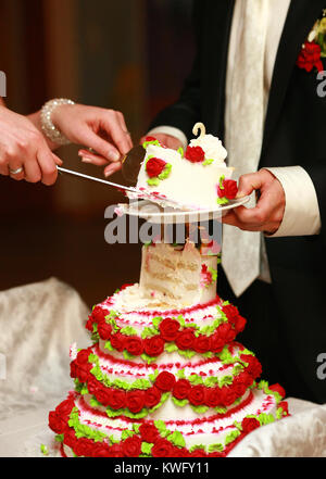 new married couple cutting beautiful Wedding Cake Stock Photo