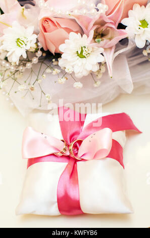 Two Golden Wedding Rings on pillow