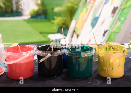 Used paint brushes with watercolor set Old paint cans and colors colorful and paint brush. Stock Photo
