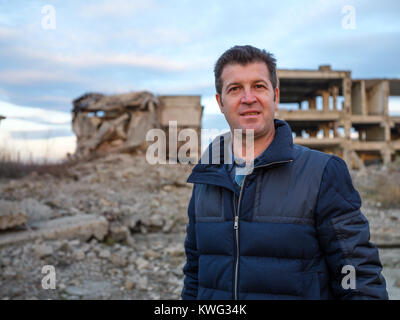 Man standing among industrial ruins Stock Photo