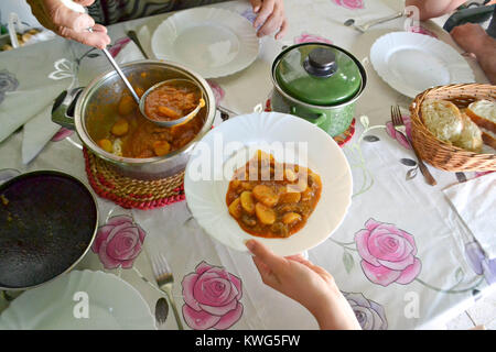 food, eating and family concept - group of people having breakfast and sitting at table Stock Photo
