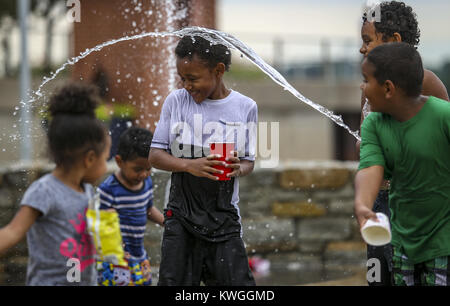 Rock Island, Iowa, USA. 2nd July, 2017. Casey Westerfield, 8, of Rock Island gets splashed by his brothers while playing in the fountain at Schwiebert Park in Rock Island on Sunday, July 2, 2017. Credit: Andy Abeyta, Quad-City Times/Quad-City Times/ZUMA Wire/Alamy Live News Stock Photo
