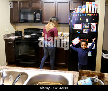 Rock Island, Iowa, USA. 2nd Nov, 2017. Davianna Lee prepares a snack for son Tariq Williams 2, in the kitchen, Thursday, November 2, 2017, in her apartment at Jackson Square in Rock Island. Tariq is wxcited about the treat. Credit: John Schultz/Quad-City Times/ZUMA Wire/Alamy Live News Stock Photo