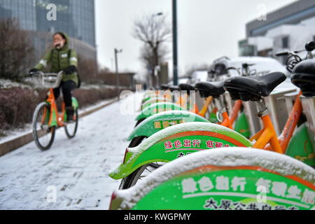 Taiyuan, China's Shanxi Province. 4th Jan, 2018. A woman rides bicycle on a snow-covered road in Taiyuan, capital of north China's Shanxi Province, Jan. 4, 2018. Many places across China saw snowfall from Wednesday. Credit: Cao Yang/Xinhua/Alamy Live News Stock Photo