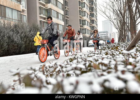 Taiyuan, China's Shanxi Province. 4th Jan, 2018. People ride bicycle on a snow-covered road in Taiyuan, capital of north China's Shanxi Province, Jan. 4, 2018. Many places across China saw snowfall from Wednesday. Credit: Cao Yang/Xinhua/Alamy Live News Stock Photo