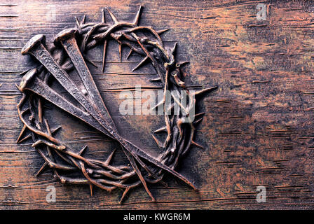 Crown of thorns and nails engraved on stone Stock Photo