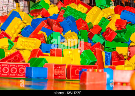 Many colorful plastic pieces in a kids' ballpit Stock Photo