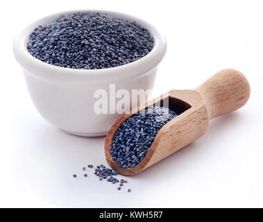 Poppy seeds in a bowl with scoop over white Stock Photo