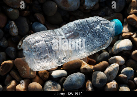 Plastic bottle washed up on a beach Stock Photo