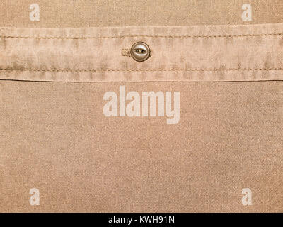 plain brown cotton shirt texture with button in close up Stock Photo