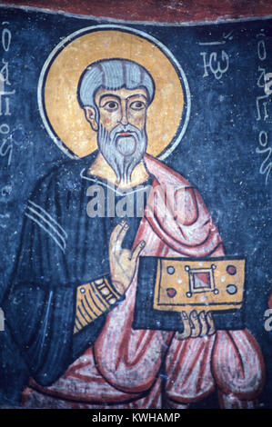 Saint John the Evangelist Holding The Bible (c11th) Byzantine Fresco or Wall Painting in the Rock-Cut or Rock Cut Eski Gumus Monastery, Eskigumus Monastery, or Gumusler Monastery, Gumusler, near Nigde, Cappadocia, Turkey Stock Photo