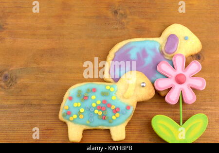 Easter cookies and a colorful flower on wooden background. Easter cookies and a colorful flower on wooden background. Stock Photo