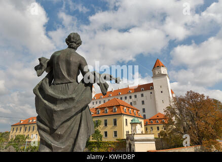 Statue of Liberty in front of medieval castle on the autumn hill in Bratislava, Slovakia. Stock Photo