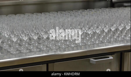 Rows of empty wine glasses lined on the showcase closeup Stock Photo