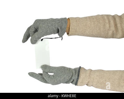 Hands in grey woolen gloves holding a blank price tag, on white background Stock Photo