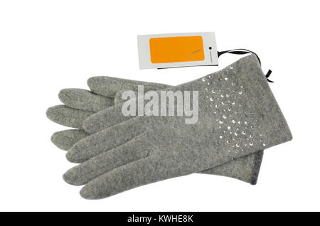 Pair of grey woolen gloves with a blank white-orange price tag beside it, on white background Stock Photo