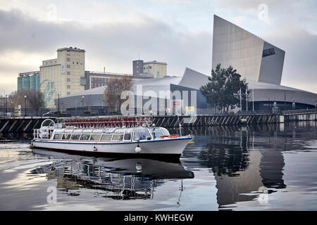 Modern Imperial War Museum North ( IWM North) Trafford Park, Greater Manchester, England. Bridgewater Cruise leaving on Ship Canal Salford Quays Stock Photo