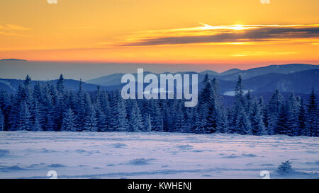 The beautiful view into the Vosges from the Stübenwasen in the Black Forest in Germany. Picture taken during a fantastic sunset on an extremely cold w Stock Photo