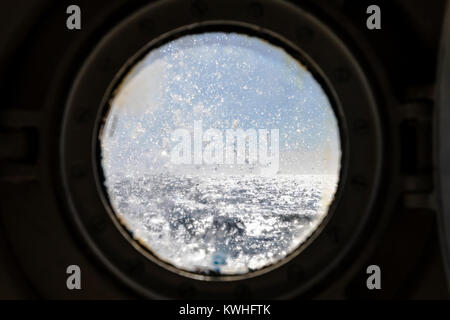 Ocean Adventurer ship port hole view of rough Drake Passage; Pasaje de Drake; Mar de Hoces; Sea of Hoces; ocean between South America & Antarctica Stock Photo