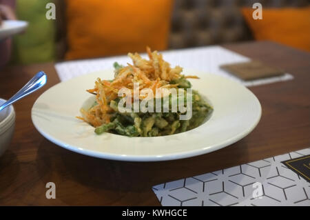 Thai cuisine, Deep fried morning glory and carrot with spicy salad sauce. Stock Photo
