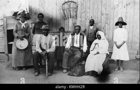 Former slave and Underground Railroad conductor Harriet Tubman (1822-1913), along with her husband, step-daughter, extended family, and former slaves she helped during the Civil War. From left to right: Harriet Tubman: Gertie Davis (Tubman's adopted daughter), Nelson Davis (Tubman's husband), Lee Cheney, 'Pop' Alexander, Walter Green, Sarah Parker ('Blind Auntie' Parker) and Dora Stewart (granddaughter of Tubman's brother, John Stewart). Photo by William Cheney, c1880s. Stock Photo