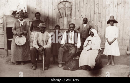 Former slave and Underground Railroad conductor Harriet Tubman (1822-1913), along with her husband, step-daughter, extended family, and former slaves she helped during the Civil War. From left to right: Harriet Tubman: Gertie Davis (Tubman's adopted daughter), Nelson Davis (Tubman's husband), Lee Cheney, 'Pop' Alexander, Walter Green, Sarah Parker ('Blind Auntie' Parker) and Dora Stewart (granddaughter of Tubman's brother, John Stewart). Photo by William Cheney, c1880s. Stock Photo