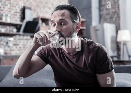 Cheerless unhappy man suffering from depression Stock Photo