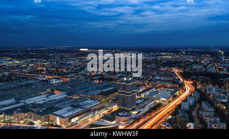 Munich, Germany - December 14, 2016: Evening Munich birds eye panoramic cityscape view with bright night lights of BMW plant and headquarters Stock Photo