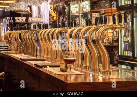 Bar counter showing array of Belgian draught beers served by taps in the Flemish café Rock Circus in the city Ghent, East Flanders, Belgium Stock Photo