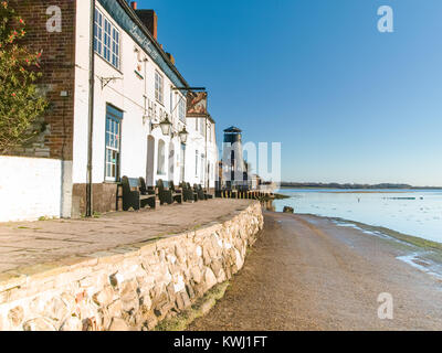 Langstone Harbour with Mill and Royal Oak on mid-winter morning at sunrise with bright winter sun and high tide Stock Photo