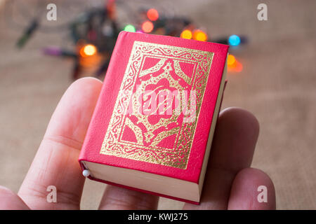 Islamic Holy Book Quran with lights behind Stock Photo