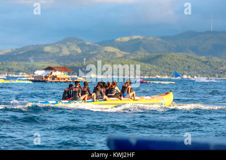 BORACAY ISLAND, PHILIPPINES - November 18, 2017 : Tourists ride a Banana Boat on Boracay sea Stock Photo